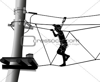 boy in adventure park rope ladder