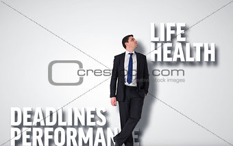 Composite image of handsome businessman leaning