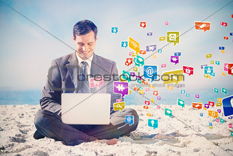 Composite image of young businessman with legs crossed typing on his laptop