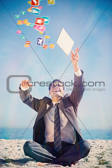 Composite image of victorious young businessman juggling with his tablet