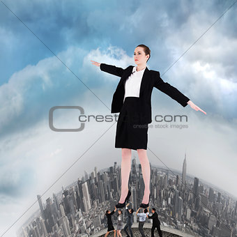 Composite image of business team supporting boss