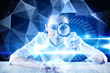 Composite image of businesswoman typing and looking through magnifying glass