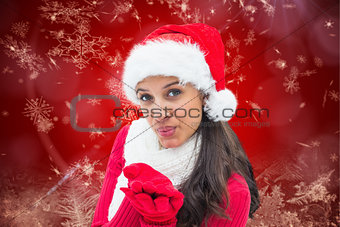 Composite image of festive brunette blowing