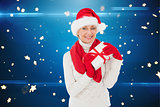 Composite image of festive woman holding gift