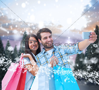 Composite image of happy couple taking a selfie
