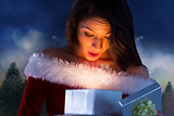 Composite image of sexy santa girl opening gift
