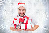 Composite image of festive man holding christmas gifts