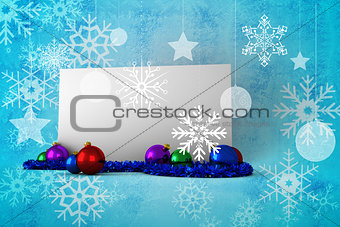 Composite image of poster with baubles