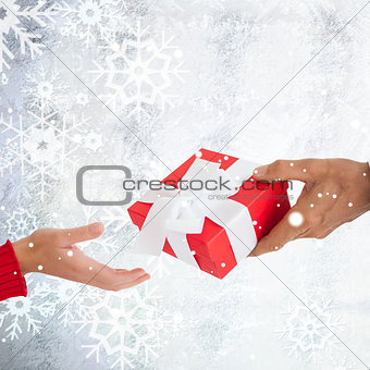 Composite image of couple holding gift