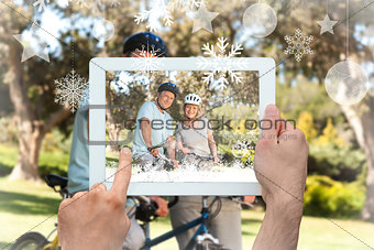 Composite image of hands holding tablet pc