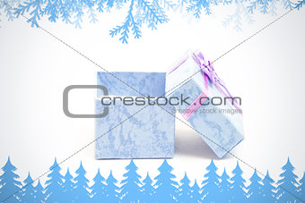 Composite image of frost and fir trees in blue