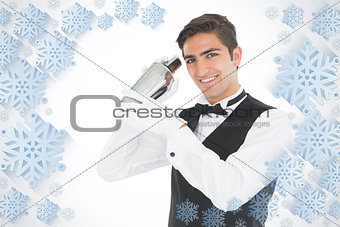 Composite image of handsome barkeeper shaking a drink