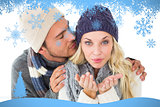 Composite image of attractive couple in winter fashion