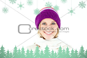 Composite image of beautiful young woman with cap in the winter smiling at the camera