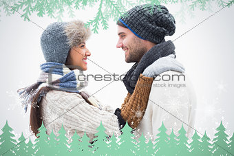 Composite image of attractive young couple in warm clothes hugging