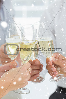 Composite image of hands toasting with champagne