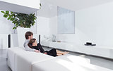 young couple on sofa watching TV