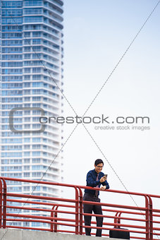 Portrait asian office worker texting mobile phone