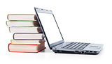 laptop and a stack of old books on white background