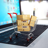 E-commerce. Shopping cart with cardboard boxes on laptop. 3d