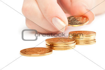 Hand put coins to stack of coins on white background