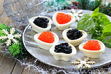 Festive Christmas appetizer tartlets with red and black caviar