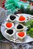 Festive Christmas appetizer tartlets with red and black caviar