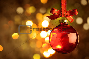 Christmas red bauble over magic bokeh  background 