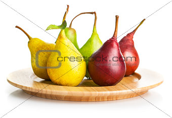 fresh pears on the wooden plate