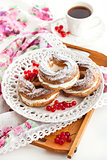 Cream puff rings decorated with fresh red currant