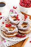 Cream puff rings decorated with fresh red currant
