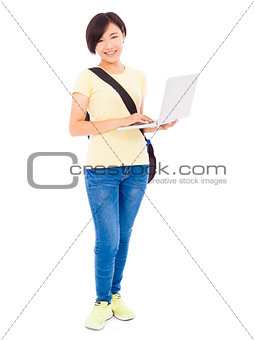 Smiling young woman holding a laptop over white background