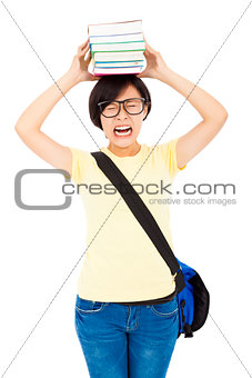 unhappy university student girl holding book on the head