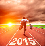 happy new year 2015. businessman running with sunrise background