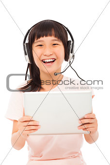 happy asian little girl holding a tablet with earphone 