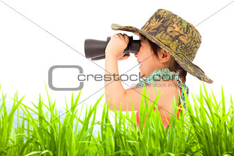Happy little girl looking through binoculars outdoors. 