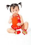 little baby girl holding a red envelope for chinese new year