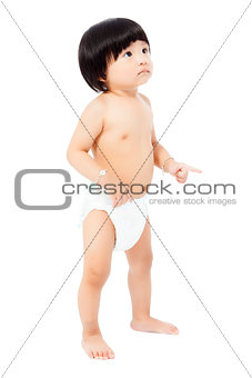 cute baby girl in a diaper standing and looks up isolated on whi