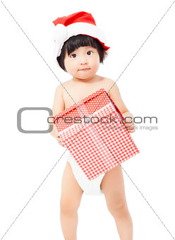 cute  baby in Santa cap holding a gift box 