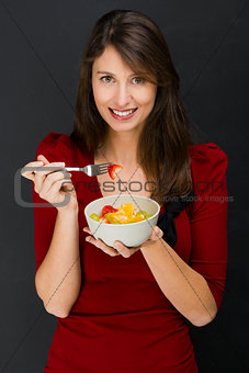Woman eating a fruit salad