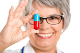 Female doctor holding  a pill