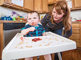 Woman Feeds Baby in Kitchen