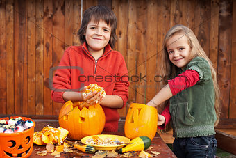 Kids carving their pumpkin jack-o-lanterns