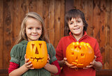 Kids with Halloween pumpkin jack-o-lanterns