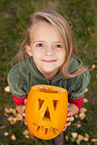 Autumn portrait with a Halloween pumpkin jack-o-lantern