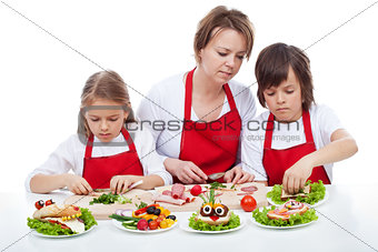 Kids and their mother preapring the party sandwiches