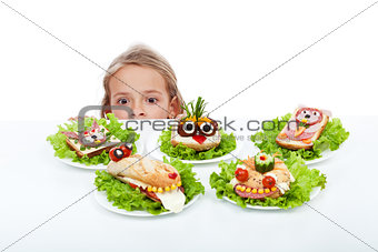 Little girl looking at creative food creatures