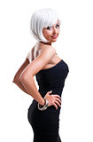 Beautiful woman wearing black dress posing over white background
