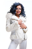 Beautiful brunette in white fur coat