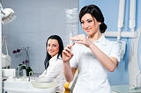 Attractive woman dentist with medical syringe and smiling patient